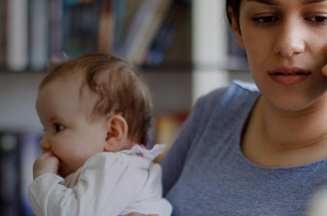 A mother with her baby calling a helpline